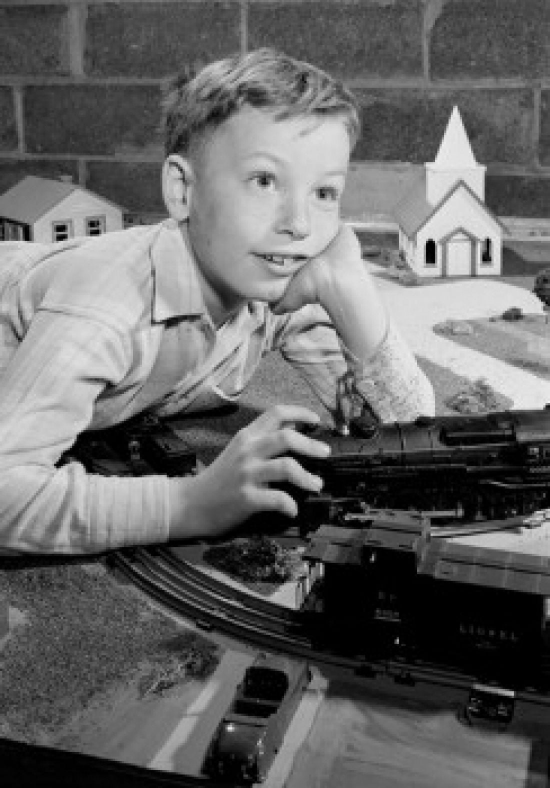 Boy playing with toy train Canvas Art - (18 x 24)
