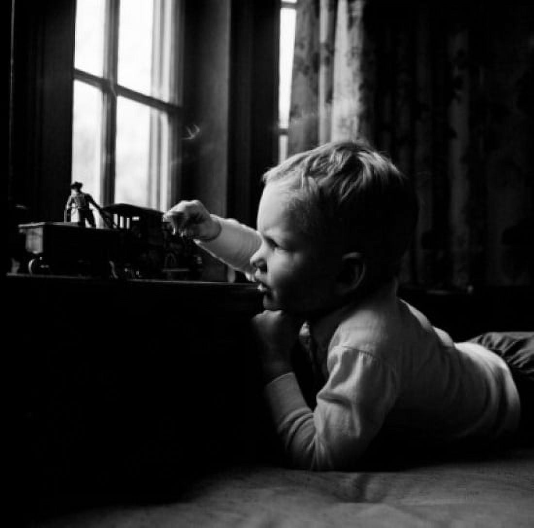 Boy playing with toy train Canvas Art - (24 x 36)