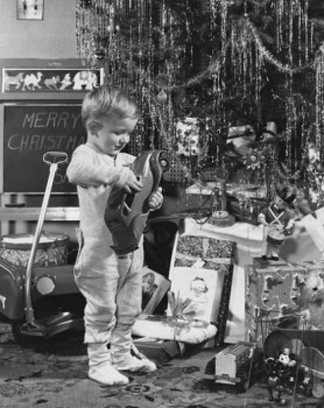 Boy playing with toys near a Christmas tree Canvas Art - (24 x 36)