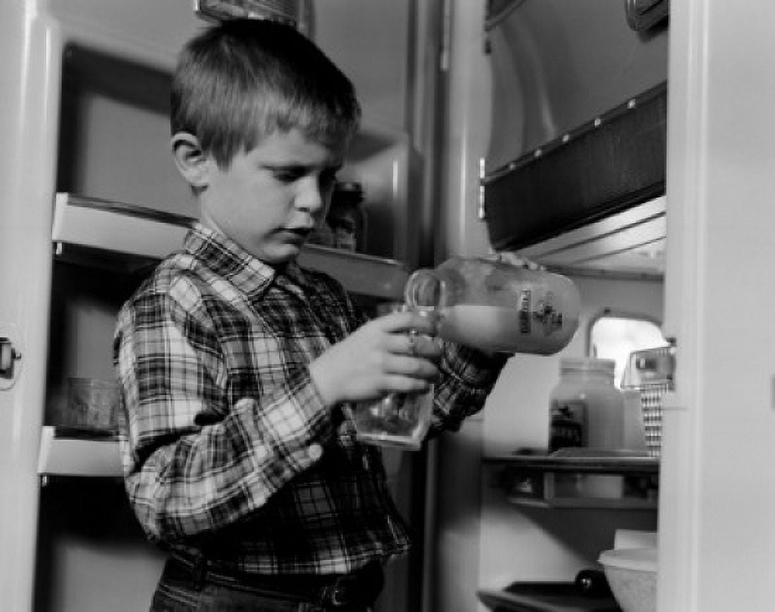 Boy pouring milk from bottle Canvas Art - (24 x 36)