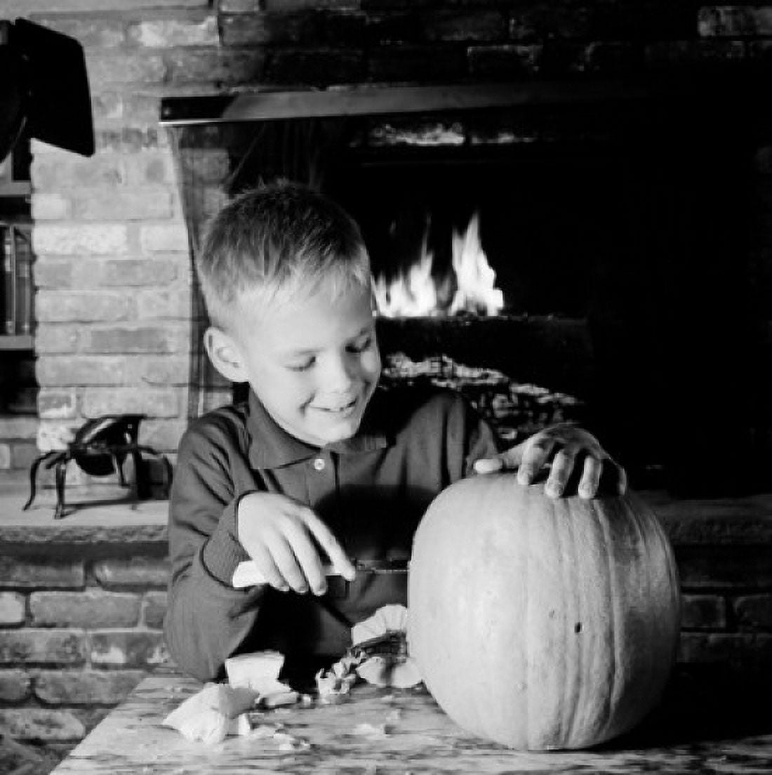Boy preparing pumpkin for Halloween Canvas Art - (24 x 36)