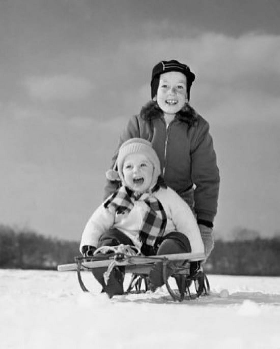 Boy pushing his brother on a sled Canvas Art - (18 x 24)