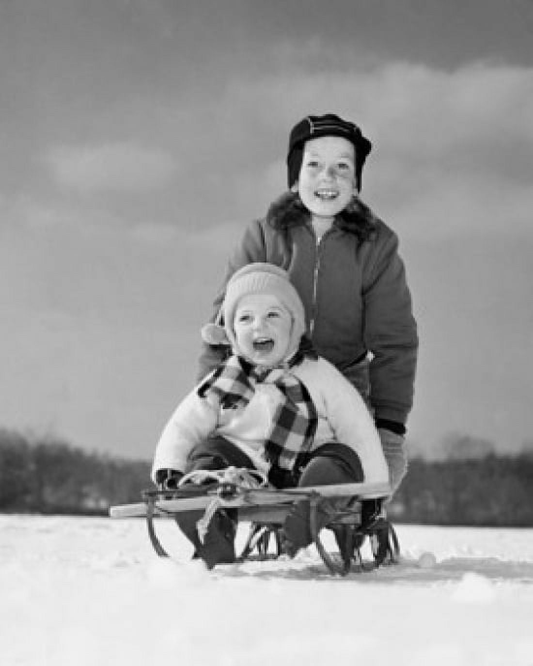 Boy pushing his brother on a sled Canvas Art - (24 x 36)