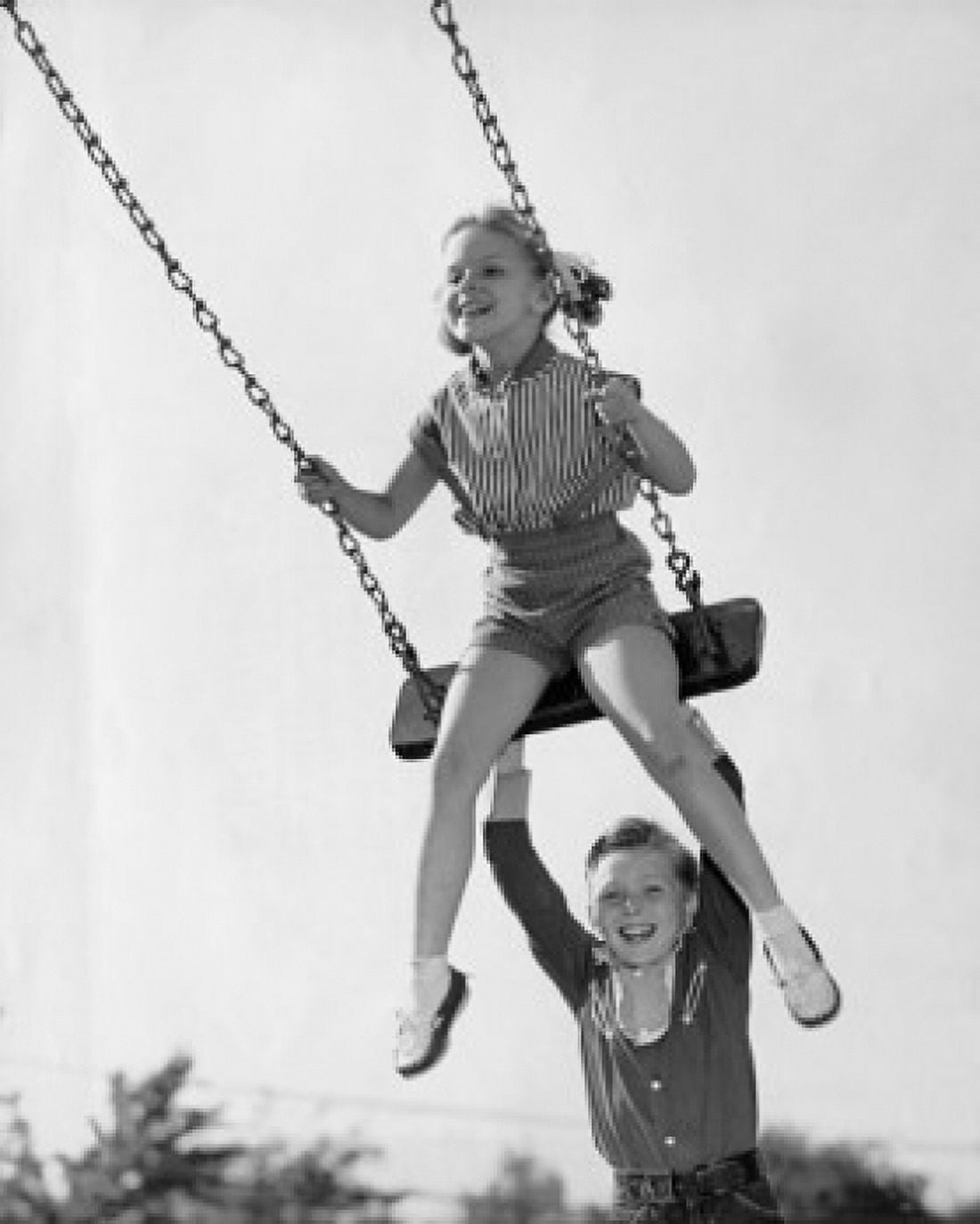 Boy pushing his sister on a swing Canvas Art - (24 x 36)