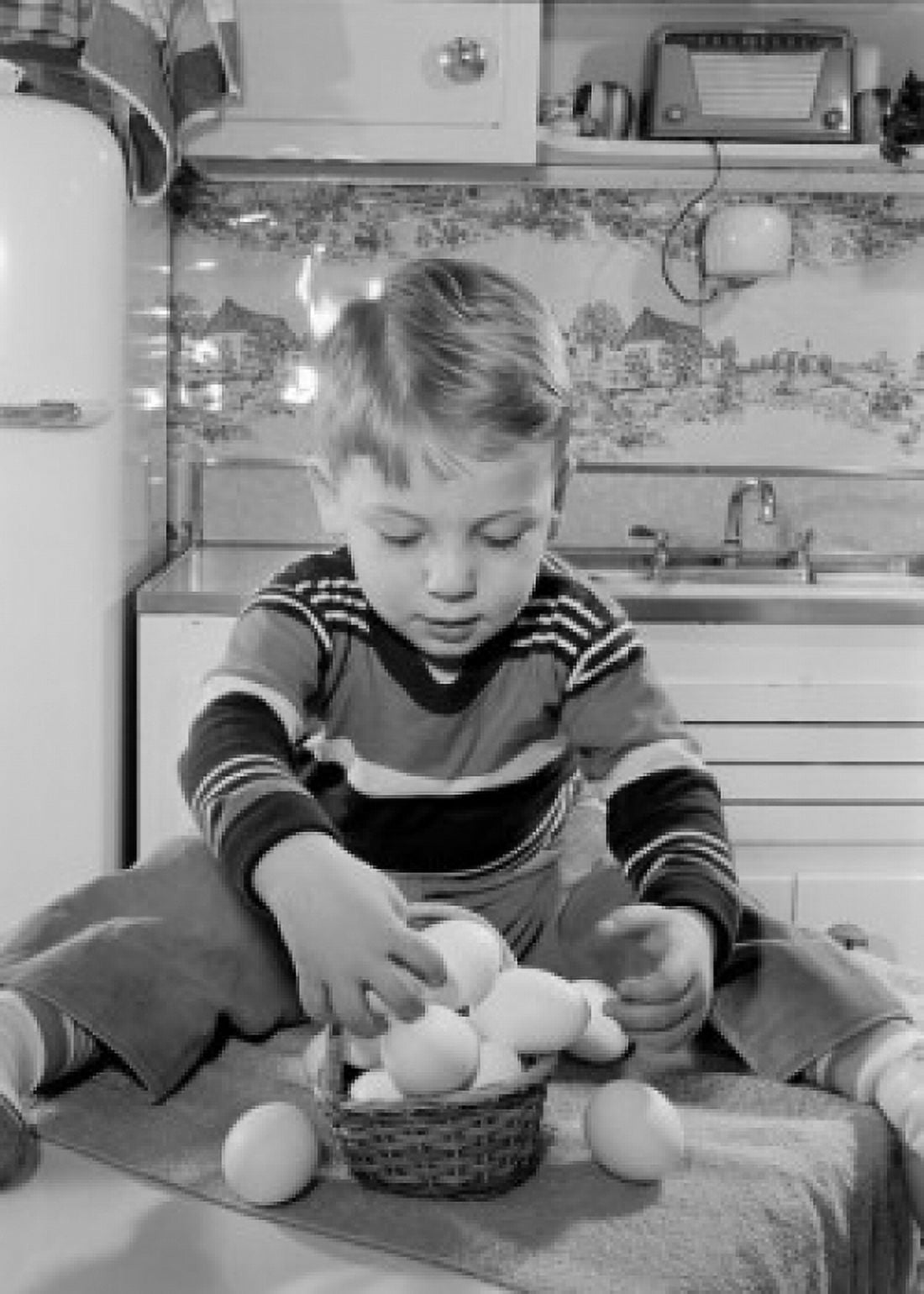 Boy putting eggs into basket Canvas Art - (18 x 24)