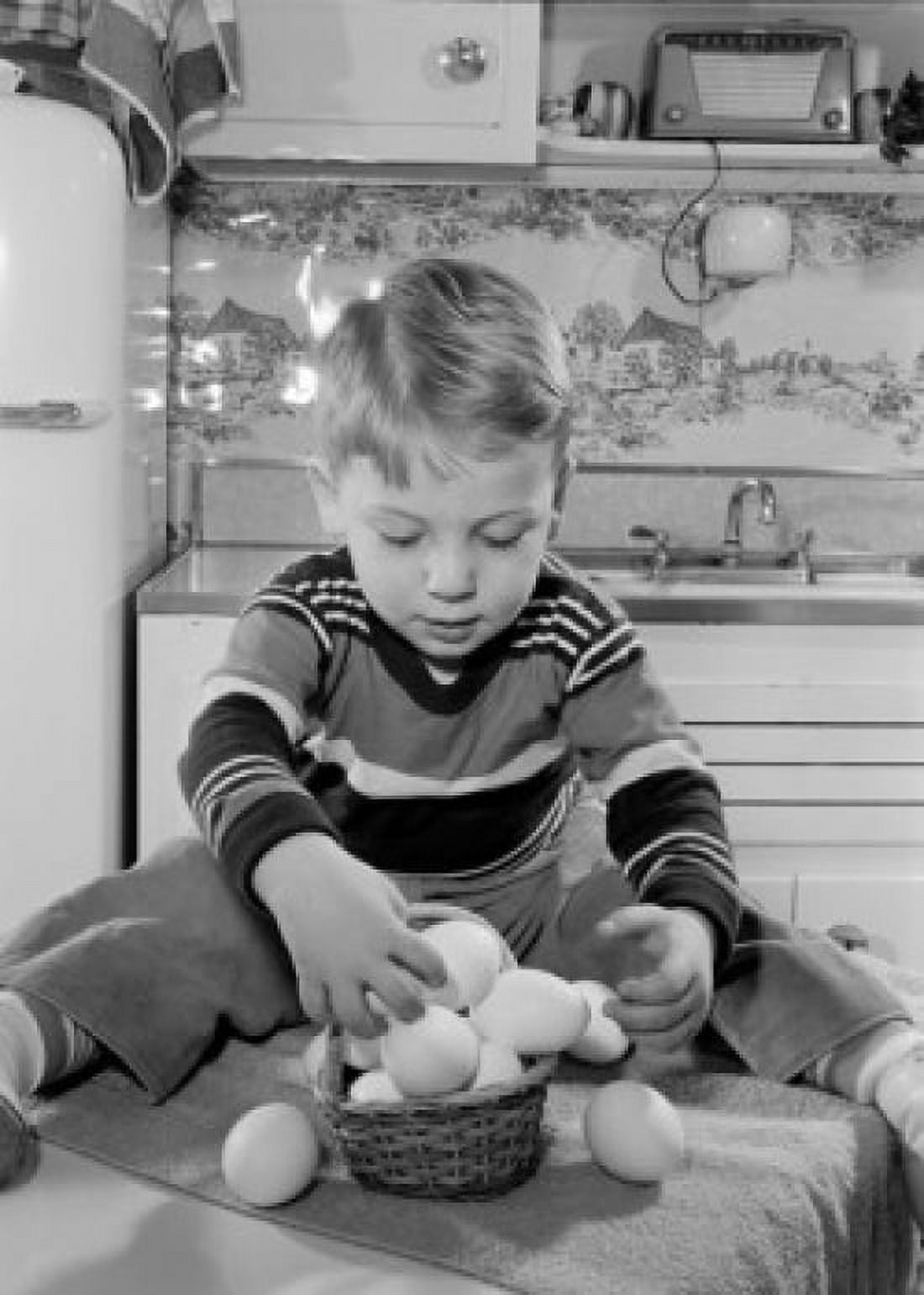 Boy putting eggs into basket Canvas Art - (24 x 36)
