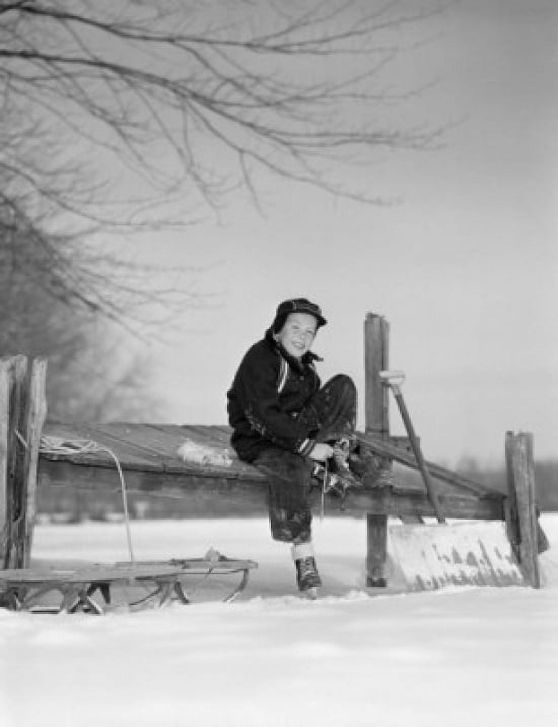 Boy putting on ice skates Canvas Art - (24 x 36)