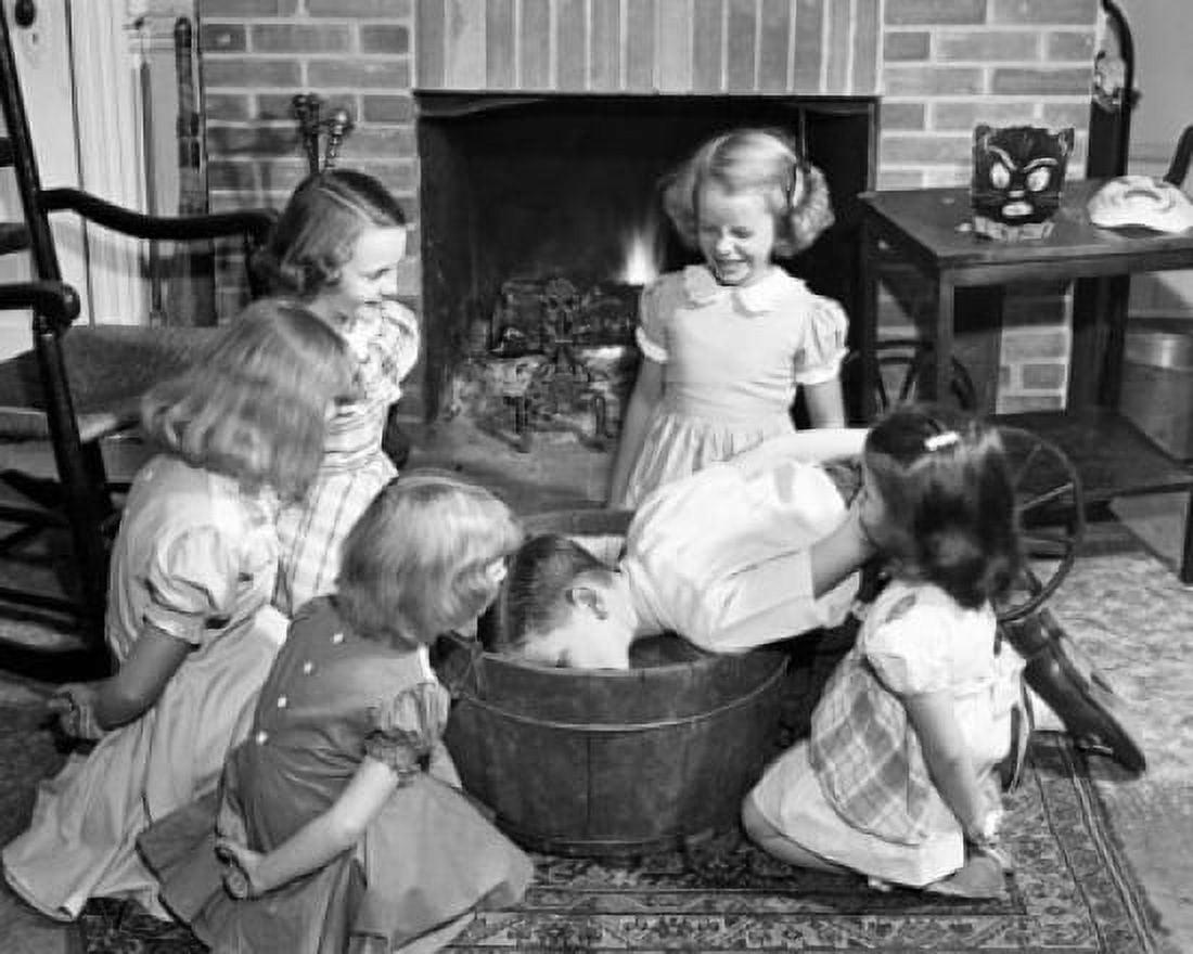 Boy reaching in a bucket with girls around him Canvas Art - (18 x 24)
