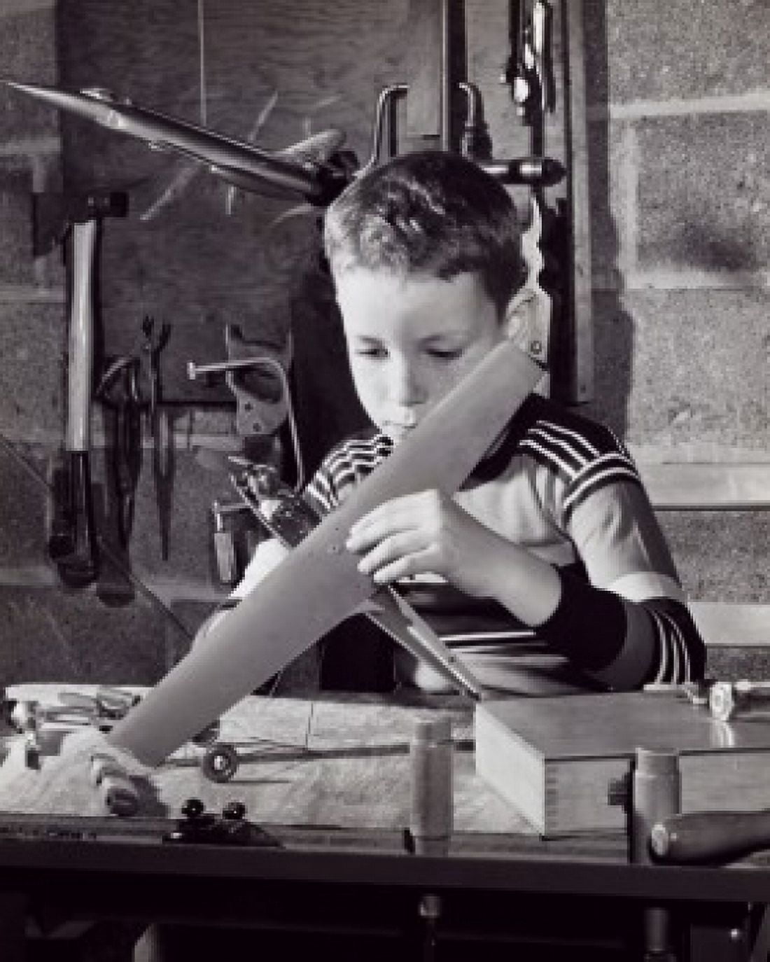 Boy repairing a model airplane Canvas Art - (18 x 24)