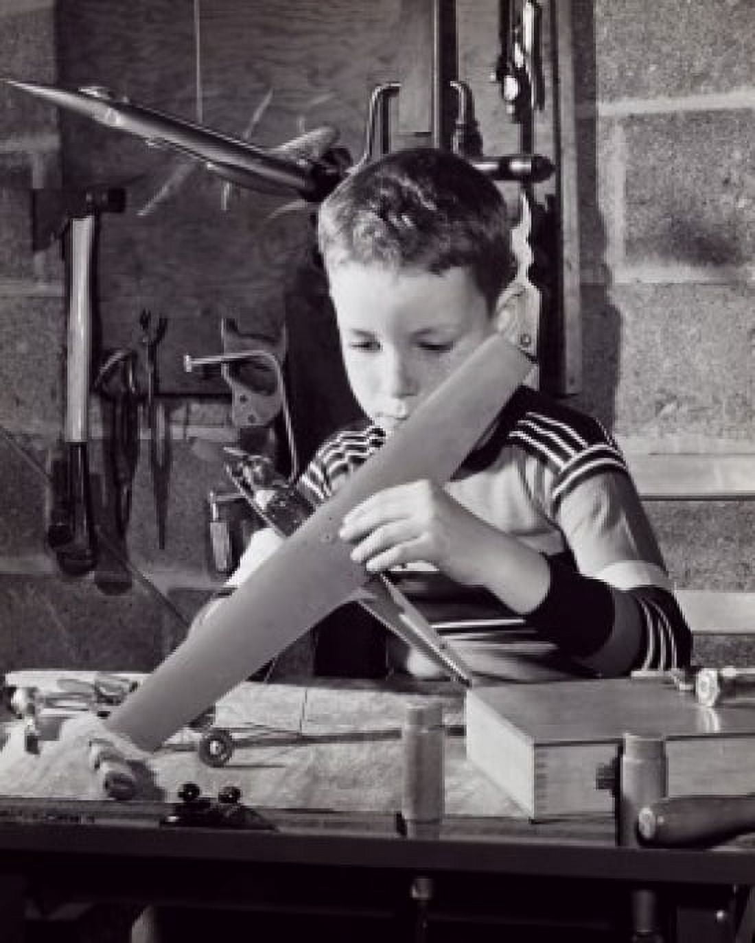 Boy repairing a model airplane Canvas Art - (24 x 36)