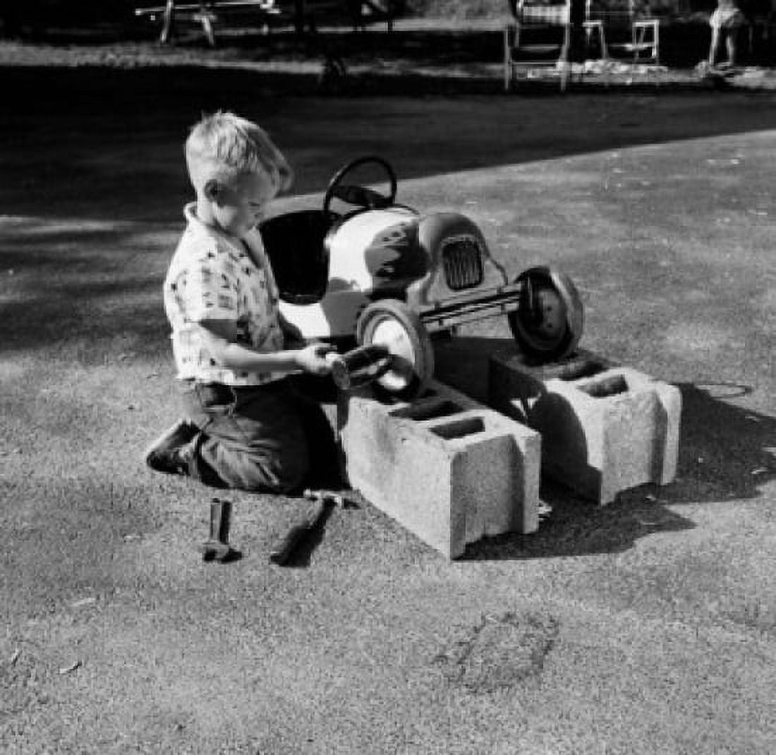 Boy repairing gocart in playground Canvas Art - (24 x 36)