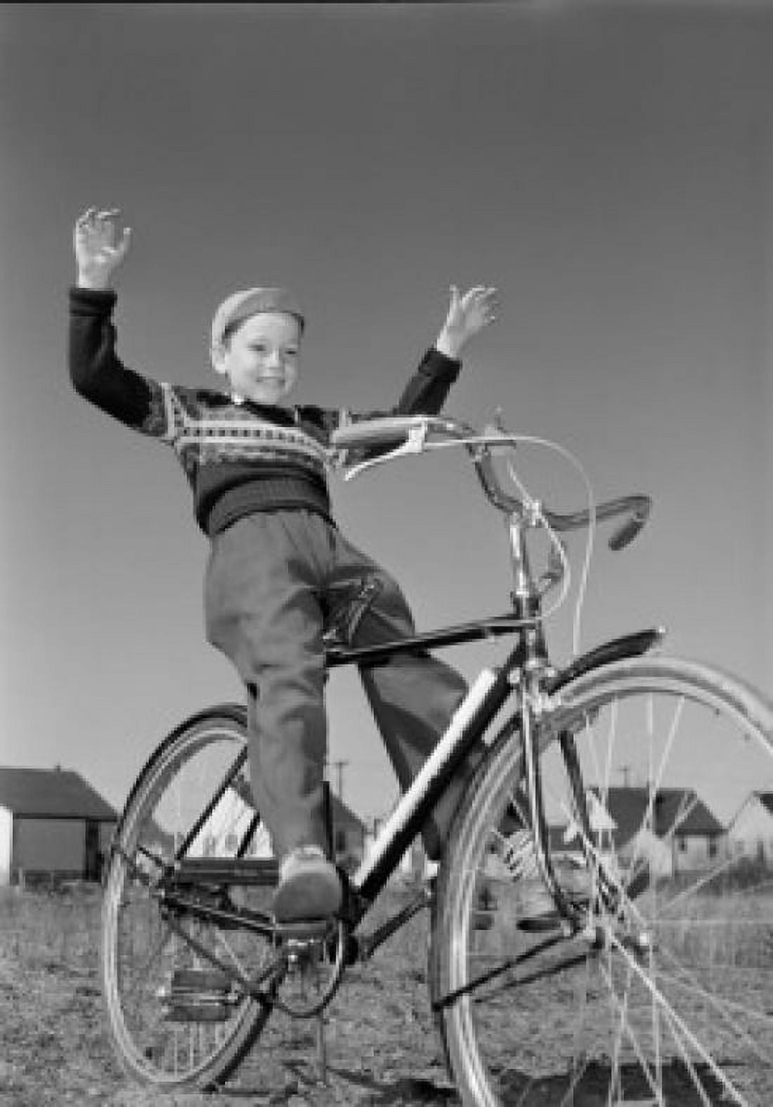 Boy riding bicycle with arms raised Canvas Art - (18 x 24)