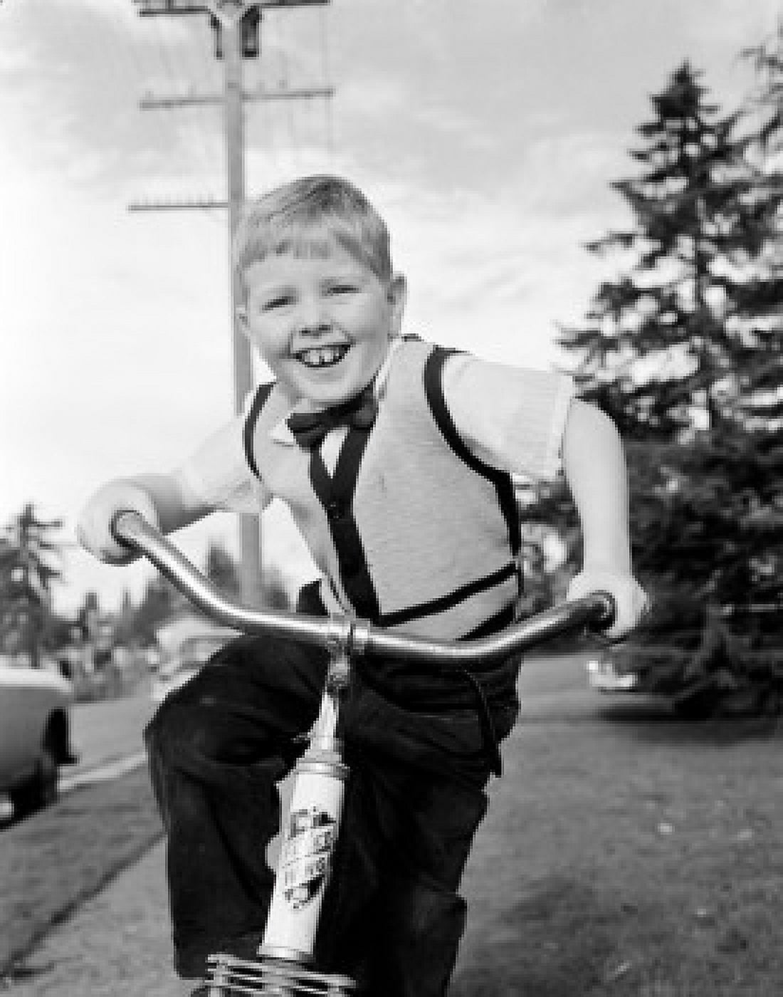 Boy riding bike smiling Canvas Art - (18 x 24)