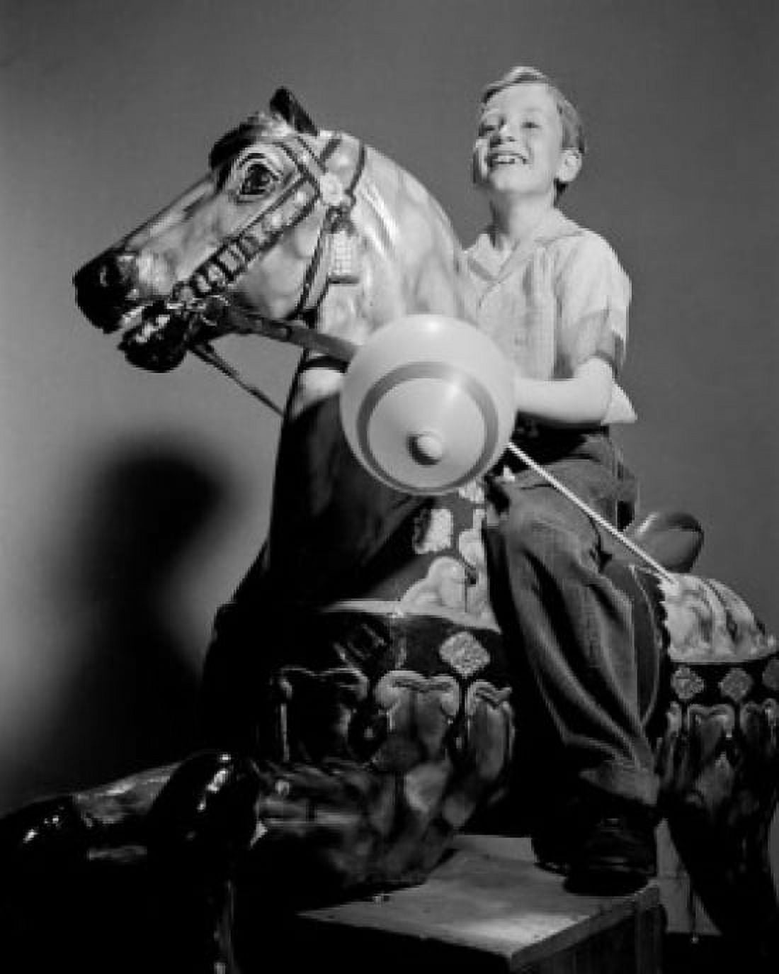 Boy riding on carousel Canvas Art - (18 x 24)