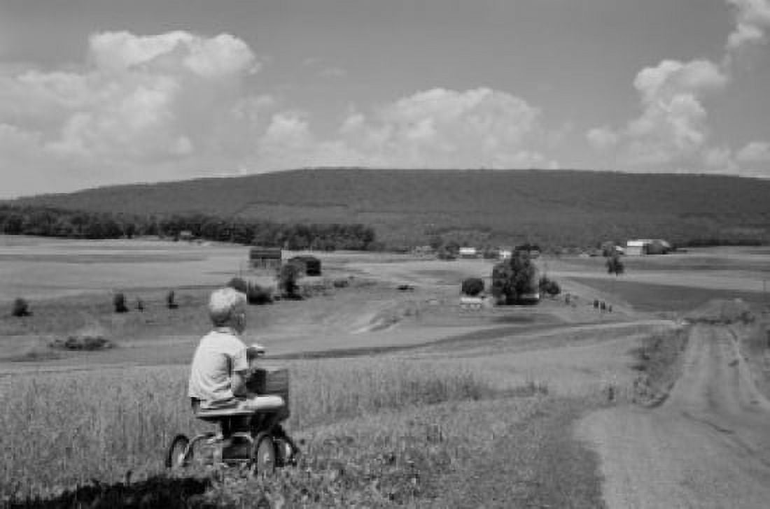 Boy riding tricycle in rural scenery Canvas Art - (24 x 36)