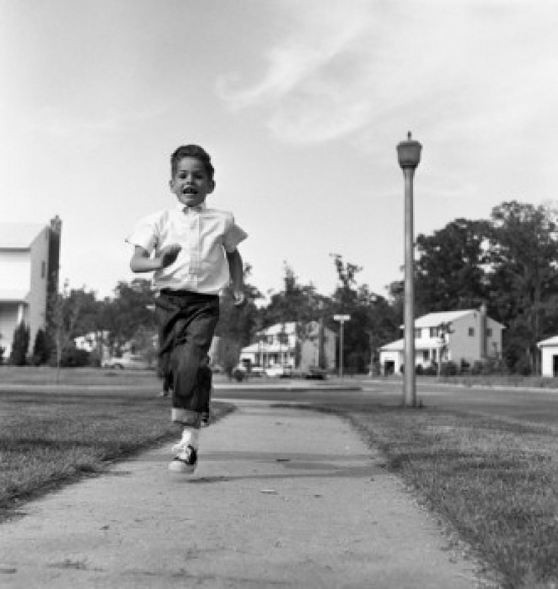 Boy running on pavement Canvas Art - (24 x 36)