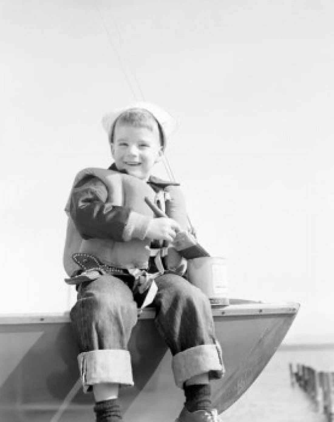 Boy sitting on boat smiling Canvas Art - (18 x 24)