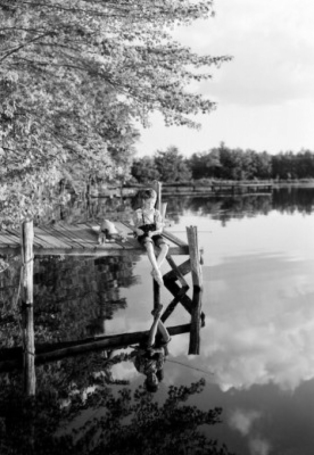 Boy sitting on jetty and fishing Canvas Art - (18 x 24)