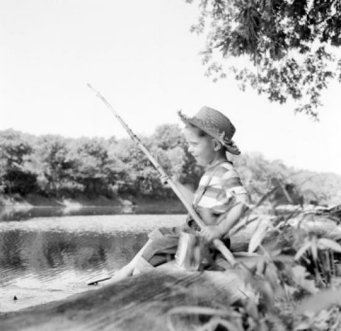 Boy sitting on riverbank and fishing Canvas Art - (24 x 36)