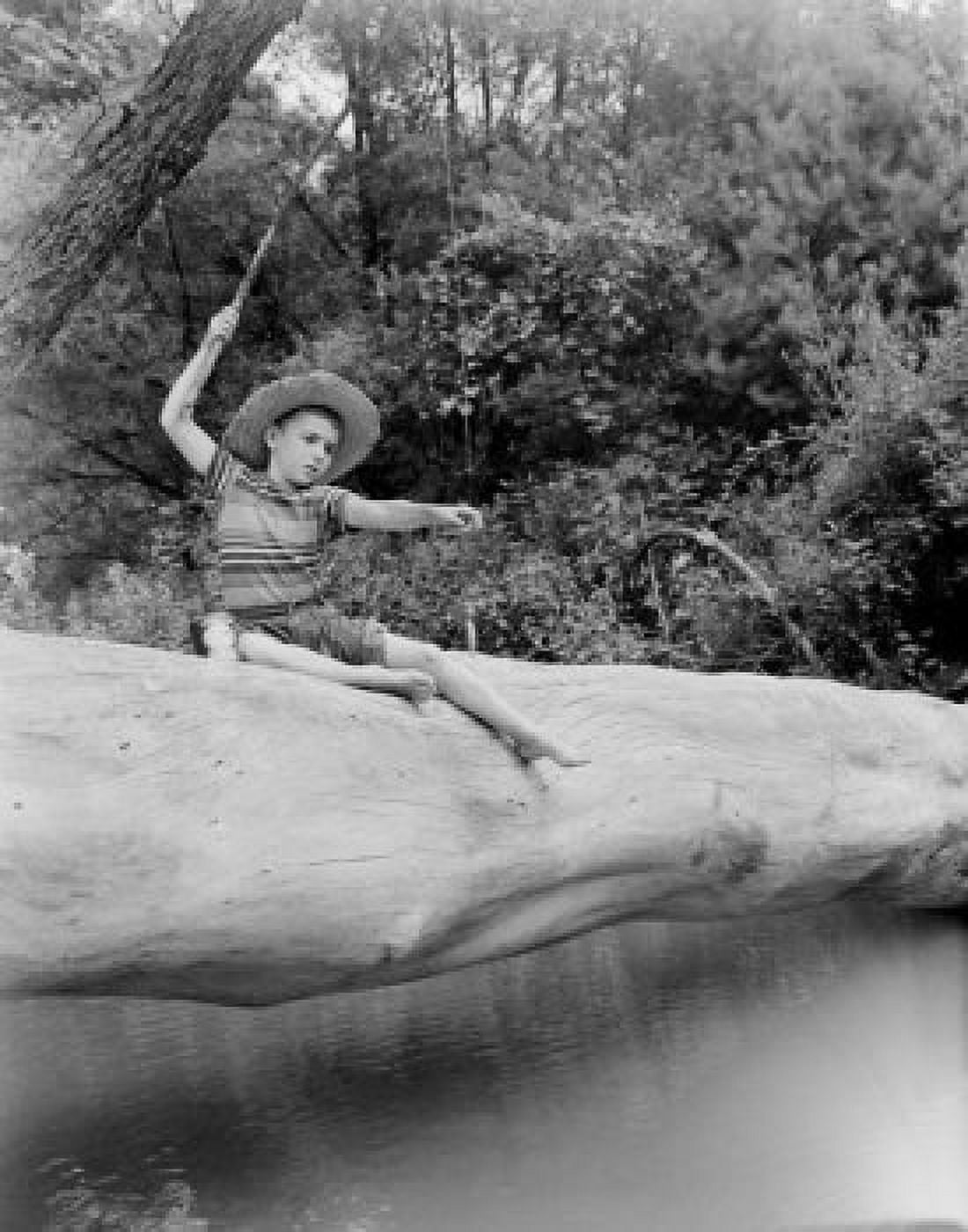 Boy sitting on tree trunk and fishing Canvas Art - (18 x 24)