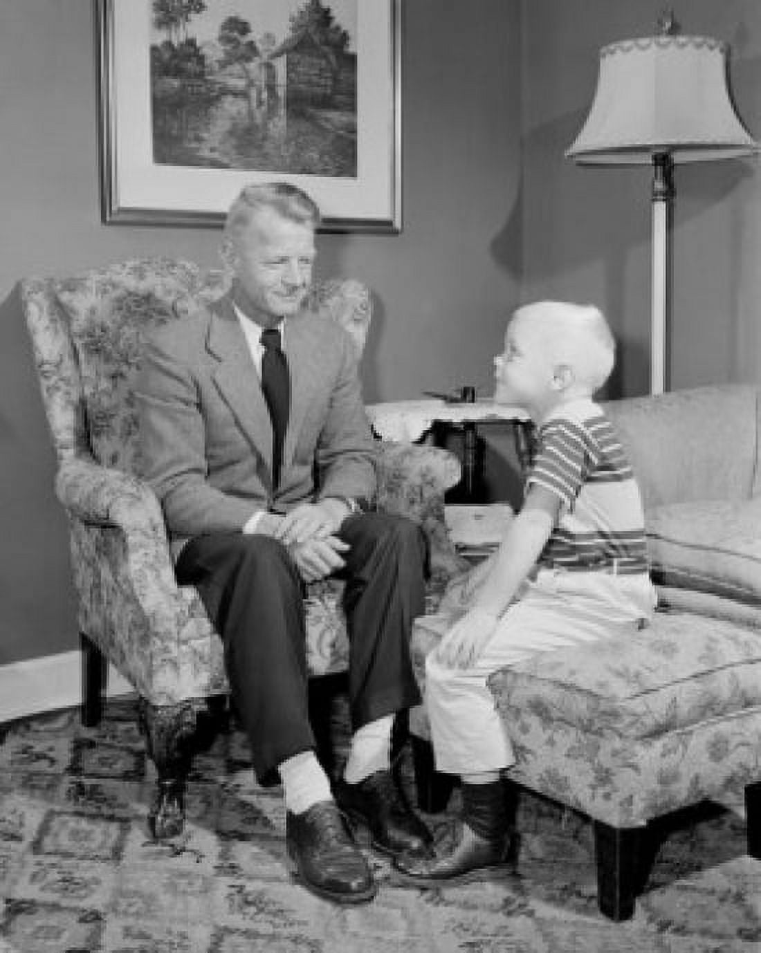 Boy sitting with grandfather in living room Canvas Art - (24 x 36)