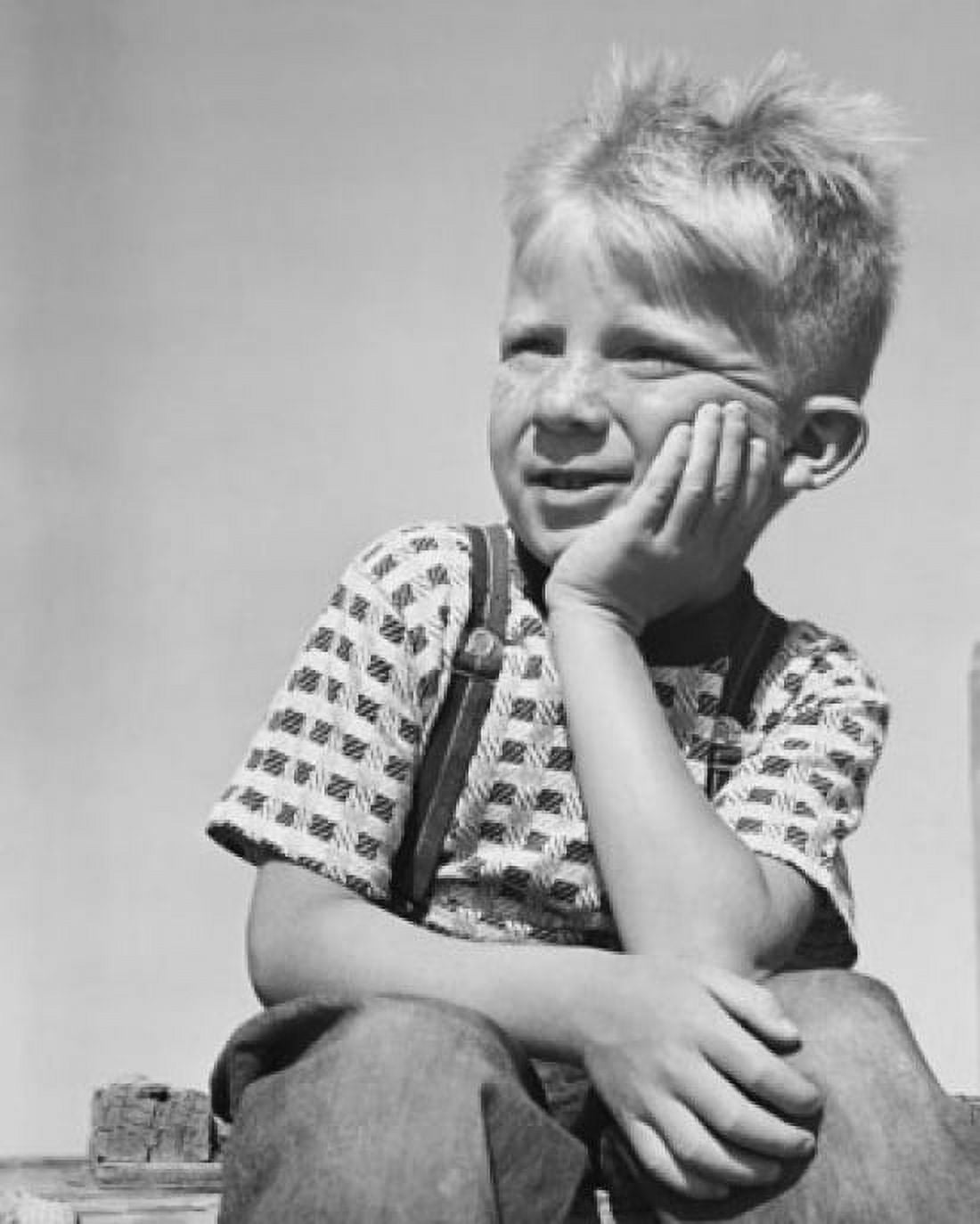 Boy sitting with hand on chin Canvas Art - (24 x 36)