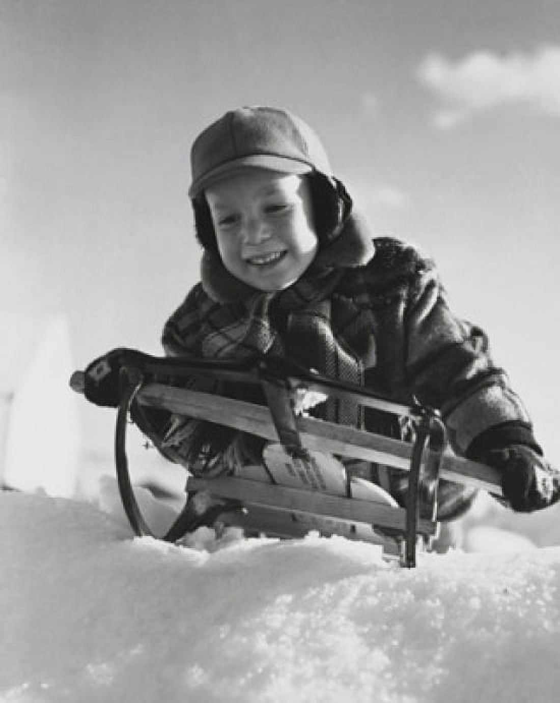 Boy sledding on snow Canvas Art - (24 x 36)
