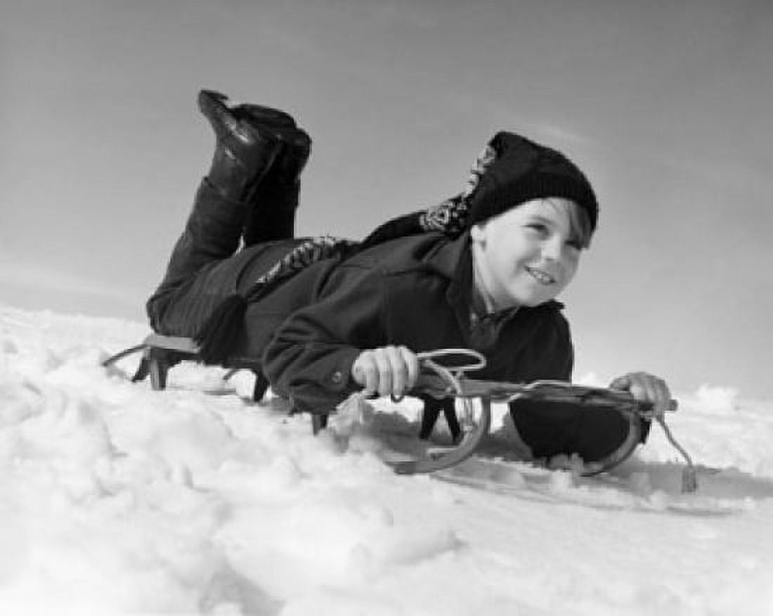 Boy sliding on a sled Canvas Art - (24 x 36)