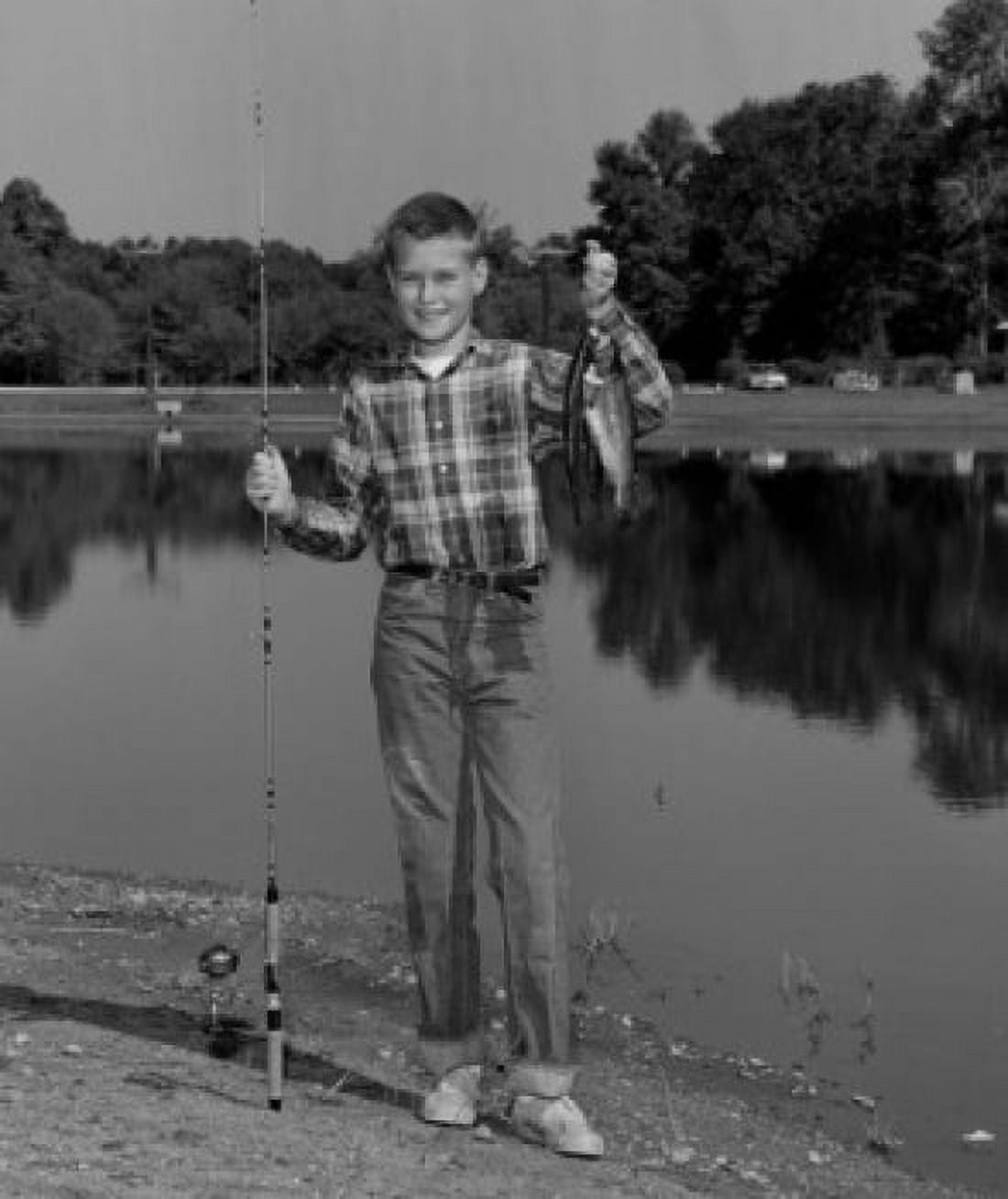 Boy standing in front of pond holding fishing rod and fish Canvas Art - (24 x 36)