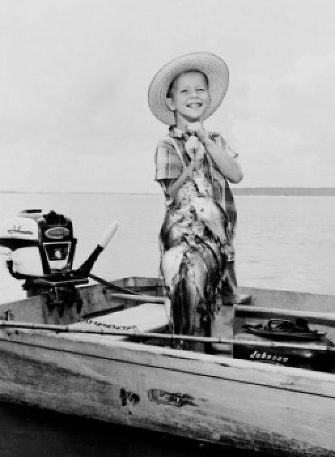 Boy standing in outboard with fine string of bass and perch Canvas Art - (24 x 36)