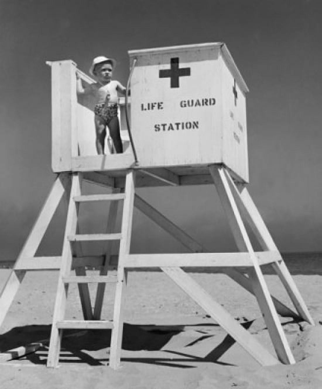 Boy standing on a lifeguard station on the beach Canvas Art - (24 x 36)