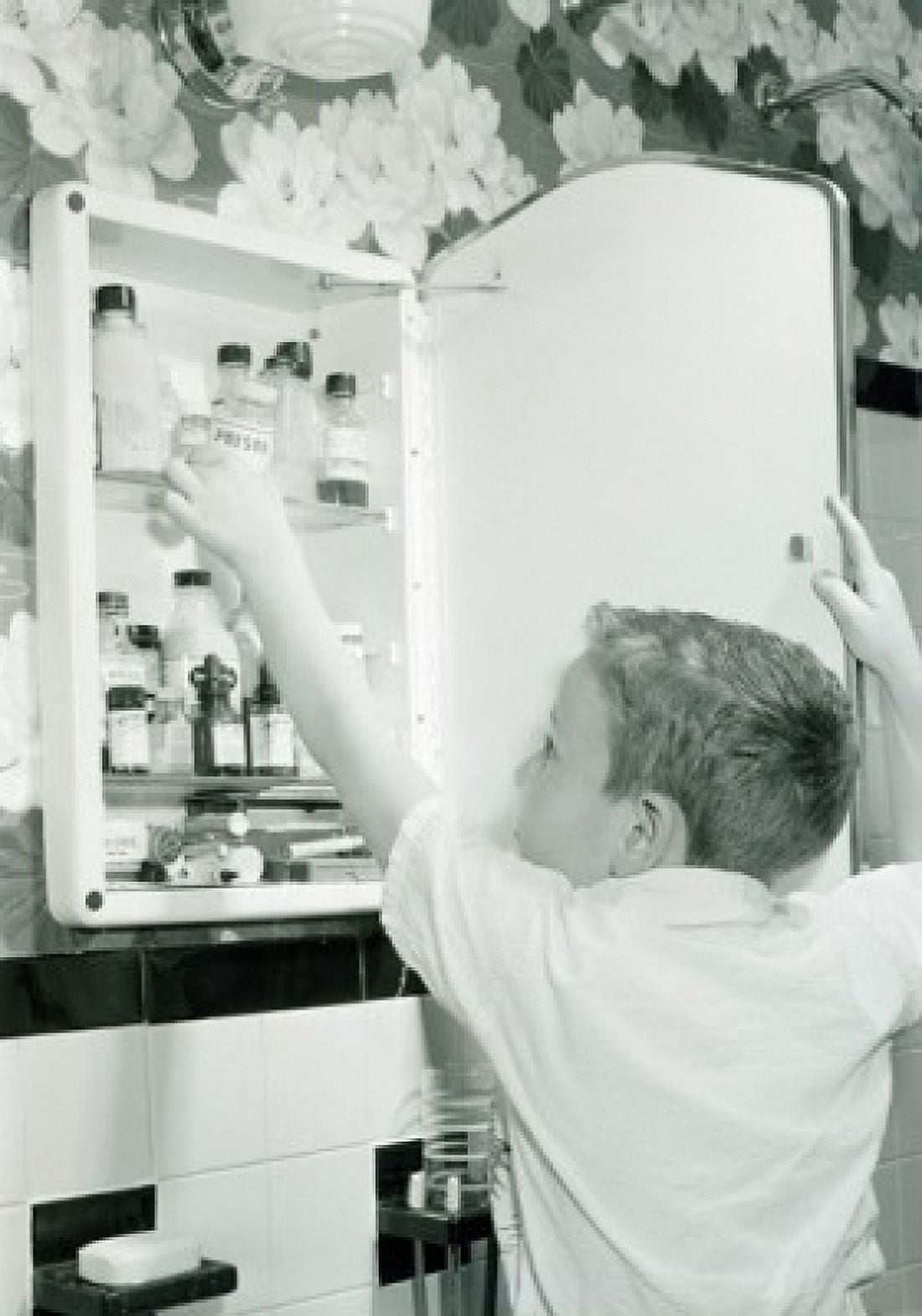 Boy taking out poison from medicine chest Canvas Art - (18 x 24)