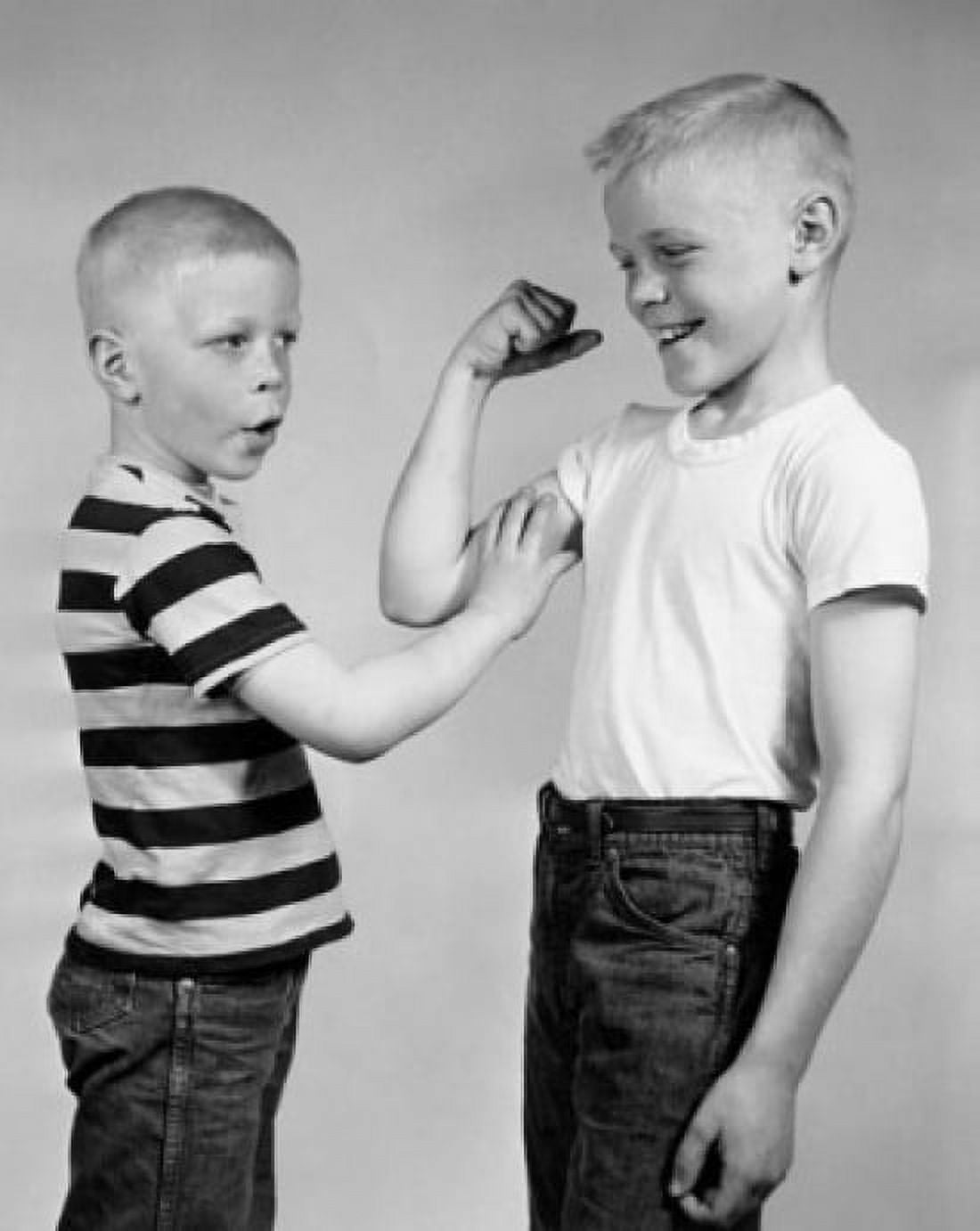 Boy touching his brothers biceps Canvas Art - (18 x 24)