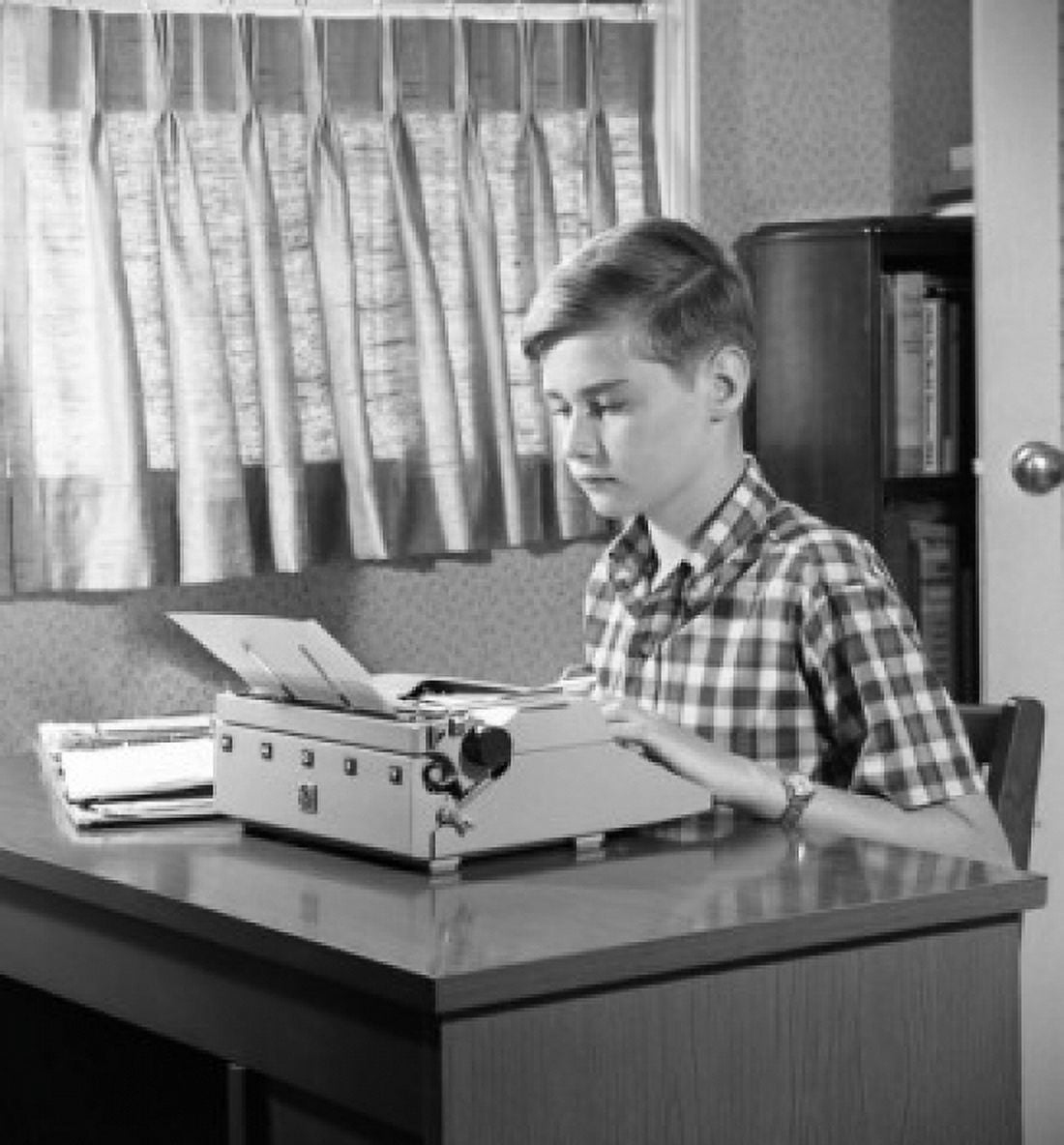 Boy typing on typewriter Canvas Art - (24 x 36)