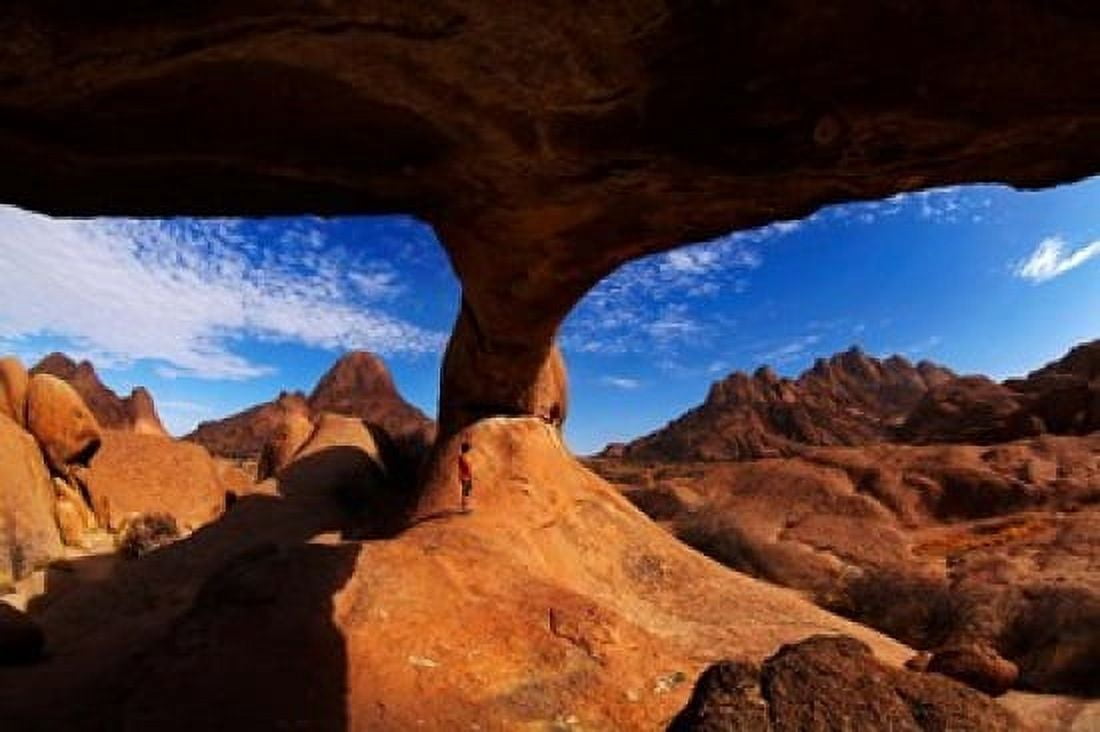 Boy under natural rock arch at Spitzkoppe Namibia Canvas Art - David Wall  DanitaDelimont (38 x 25)