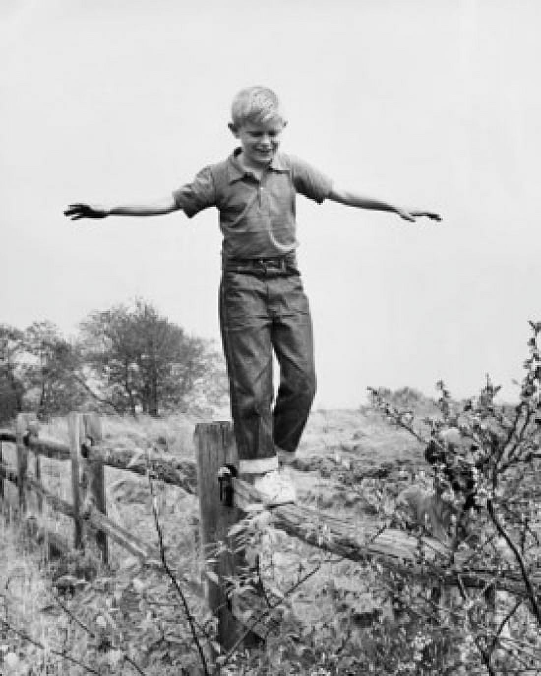 Boy walking on a fence with his arms outstretched Canvas Art - (18 x 24)