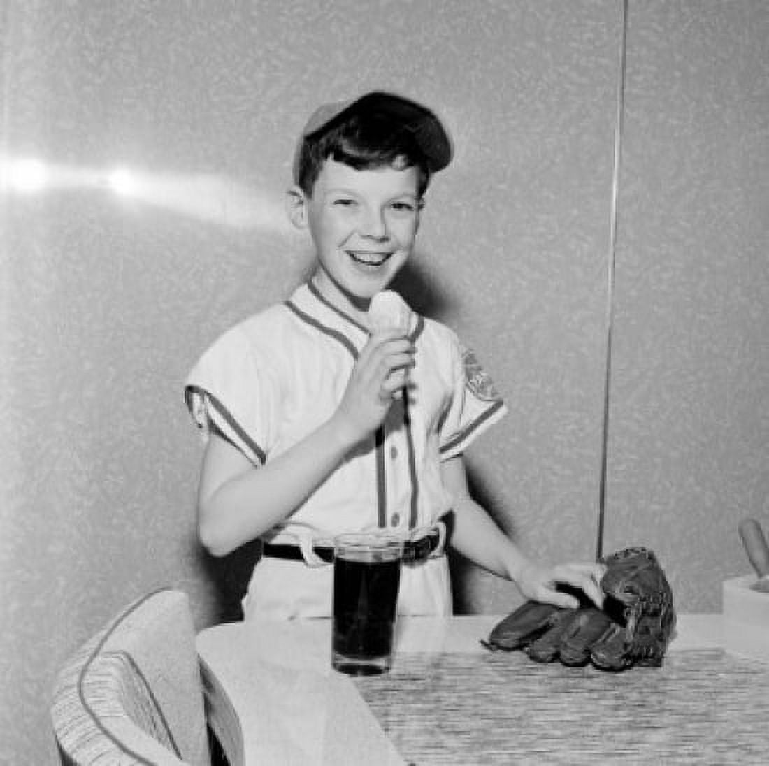 Boy wearing baseball strip eating ice cream Canvas Art - (18 x 24)