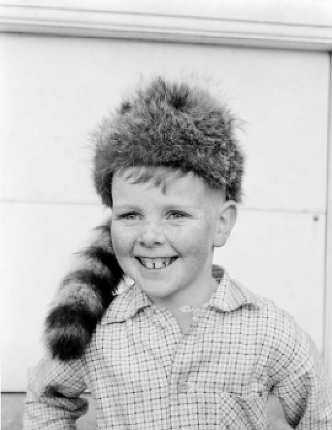 Boy wearing coonskin cap smiling Canvas Art - (24 x 36)