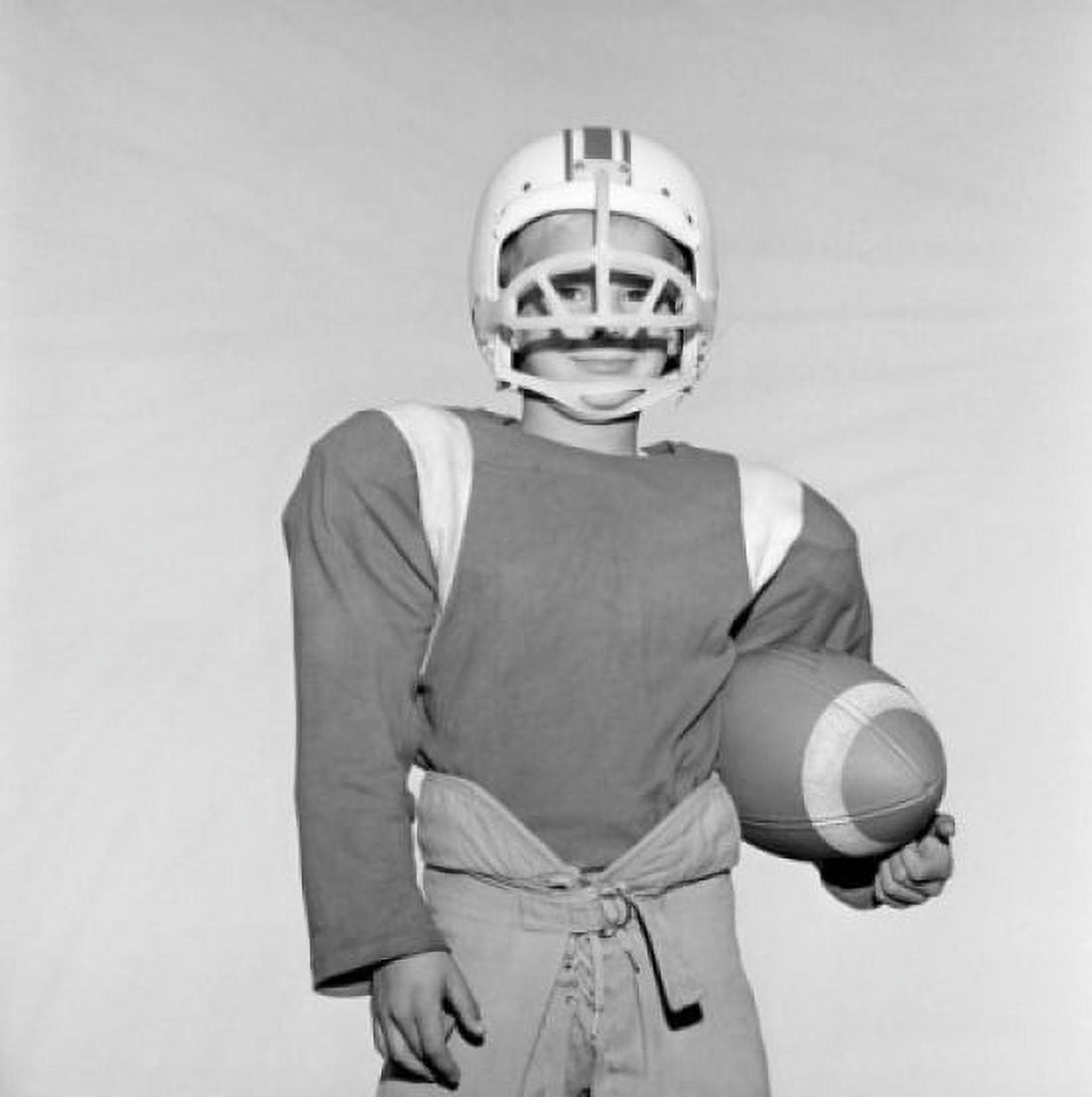 Boy wearing football helmet and holding football Canvas Art - (24 x 36)