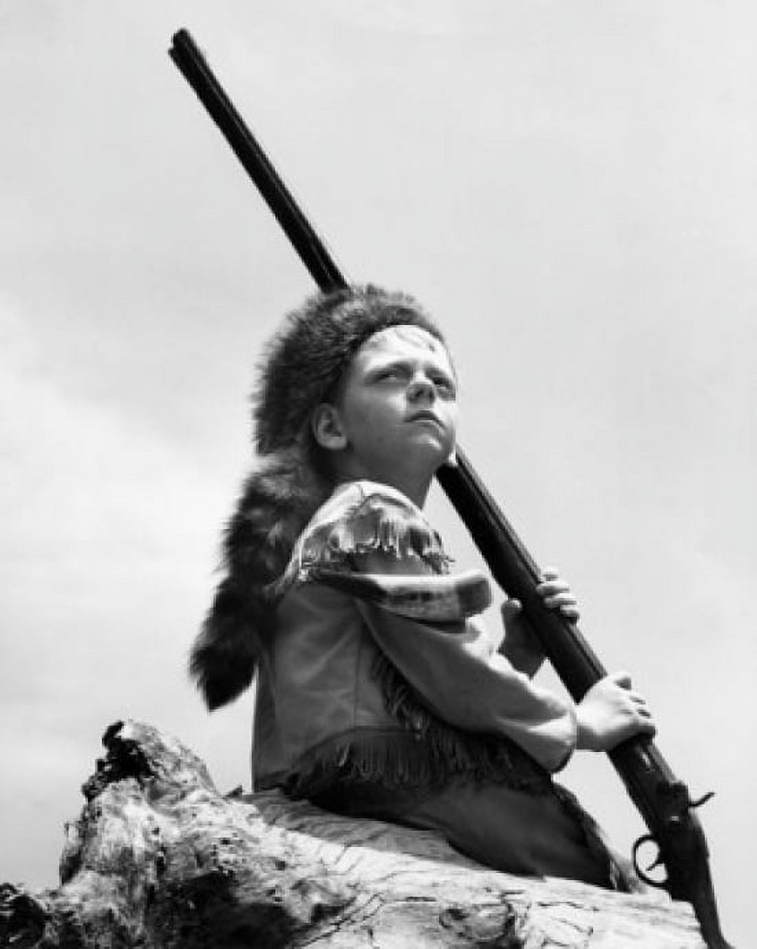 Boy wearing raccoon hat holding rifle Canvas Art - (18 x 24)