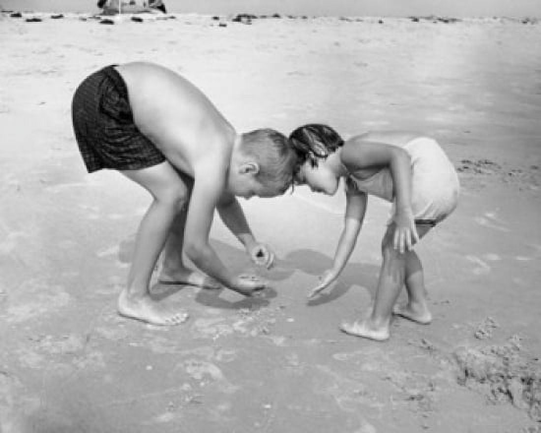 Boy with his sister collecting stones on the beach Canvas Art - (24 x 36)