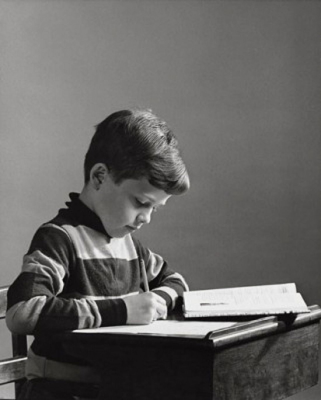 Boy writing with a pencil on a notepad Canvas Art - (24 x 36)