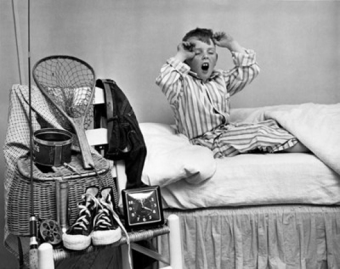 Boy yawning on bed Canvas Art - (18 x 24)