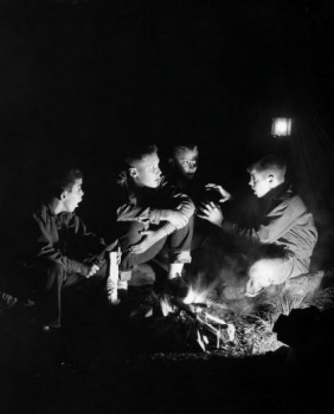 Boys listening to friend telling stories by campfire Canvas Art - (24 x 36)