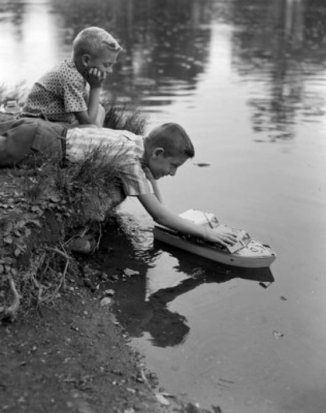 Boys playing with model boat Canvas Art - (18 x 24)