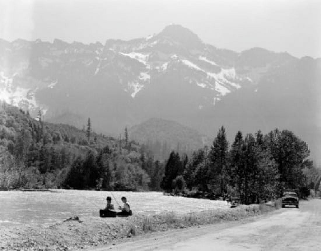 Boys sitting on riverbank and fishing Canvas Art - (18 x 24)