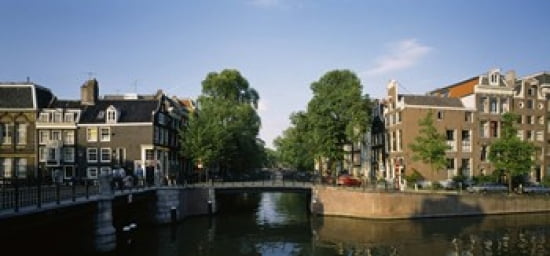 Bridge across a canal Amsterdam Netherlands Canvas Art - Panoramic Images (24 x 12)