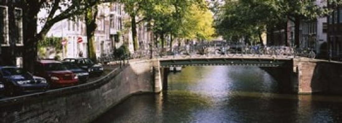 Bridge across a channel Amsterdam Netherlands Canvas Art - Panoramic Images (18 x 7)