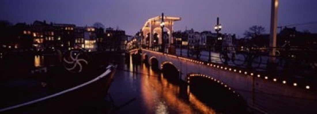 Bridge lit up at night Magere Brug Amsterdam Netherlands Canvas Art - Panoramic Images (18 x 7)