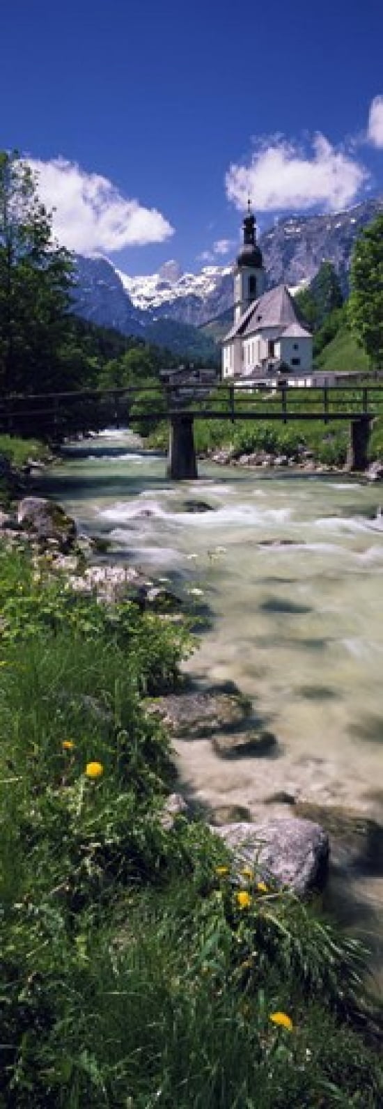 Bridge over stream below country church Bavarian Alps Germany Canvas Art - Panoramic Images (18 x 7)
